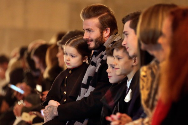 David Beckham and his children wait for the the Victoria Beckham Fall 2016 collection to be modeled during Fashion Week in New York, Sunday, Feb. 14, 2016. (AP Photo/Richard Drew)