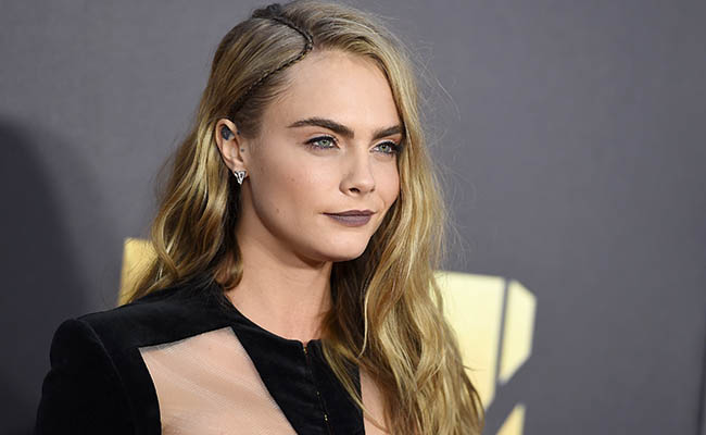 Cara Delevingne arrives at the MTV Movie Awards at Warner Bros. Studios on Saturday, April 9, 2016, in Burbank, Calif./Picture by: Jordan Strauss / Invision/Press Association Images.